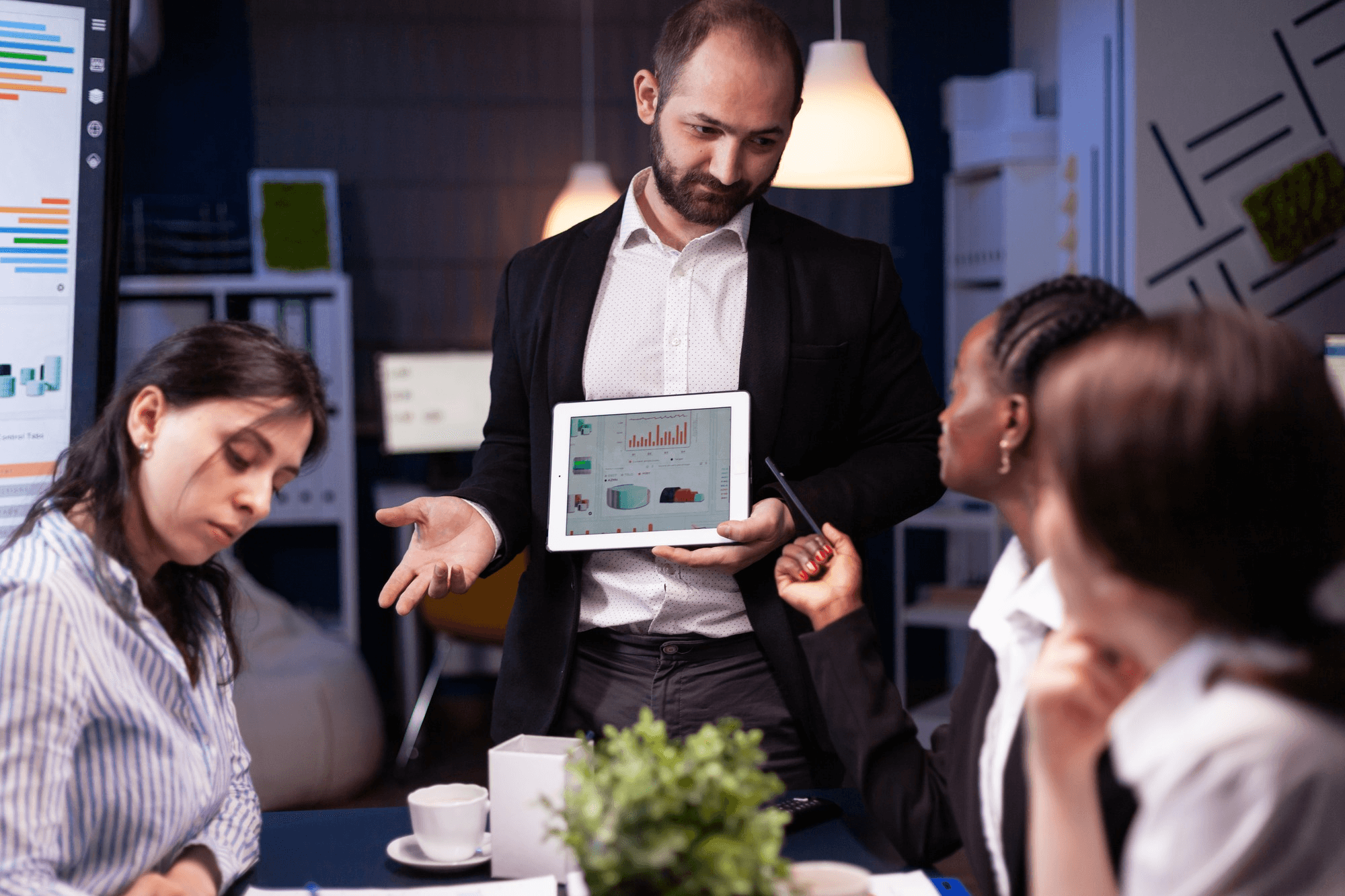 Business team reviewing technology solutions on a tablet